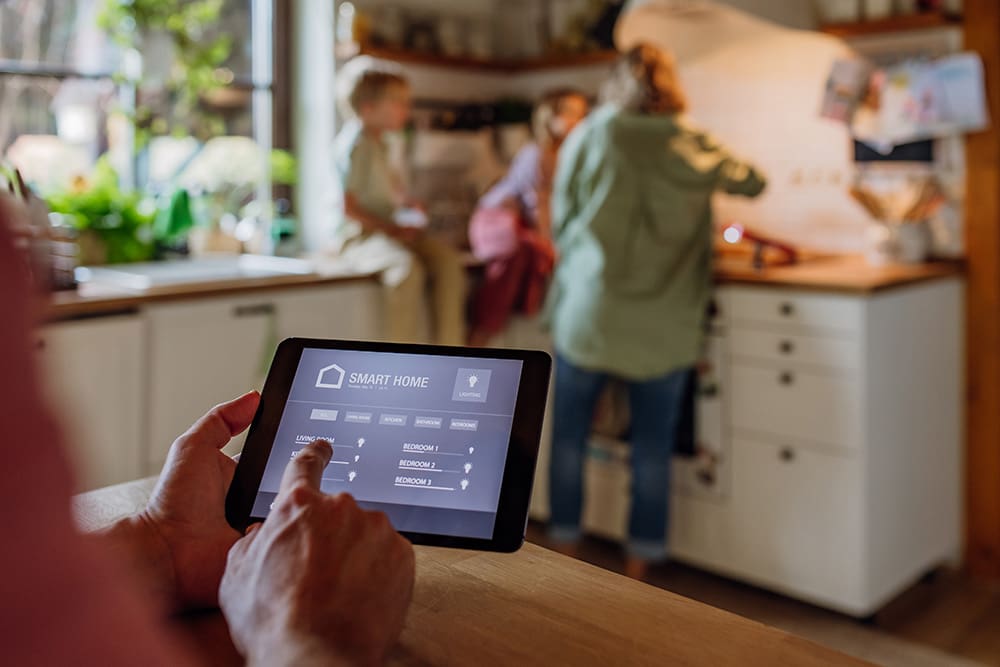 family in kitchen using smart thermostat